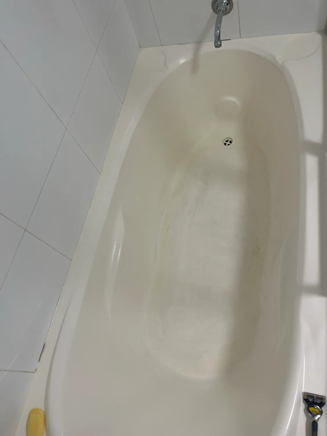 Bathtub spout and wall after cleaning