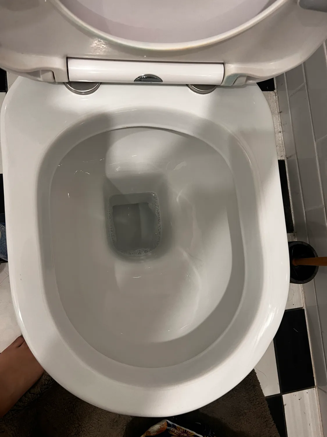 Heavily stained toilet bowl after cleaning