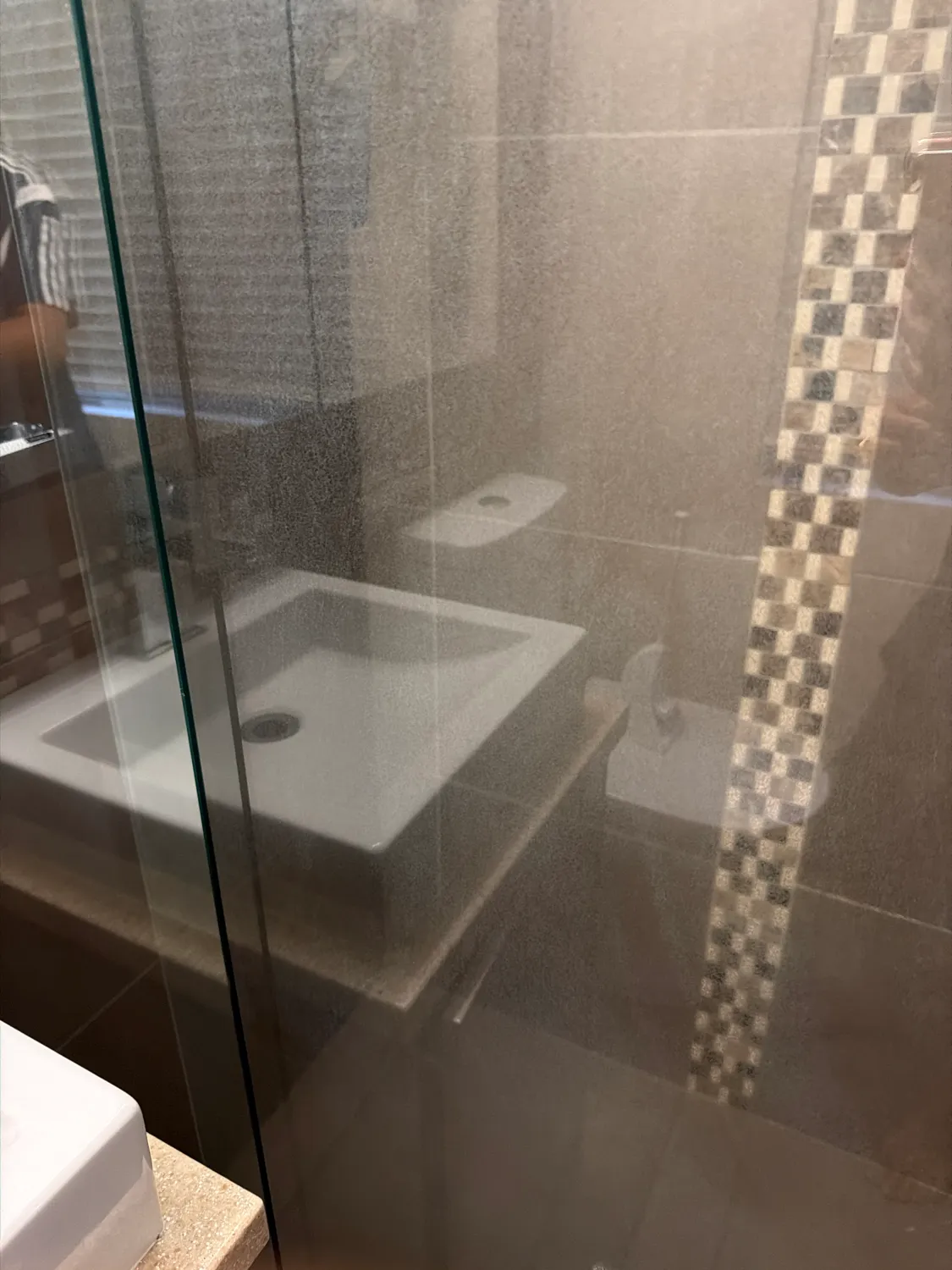 Dirty shower glass reflection after cleaning