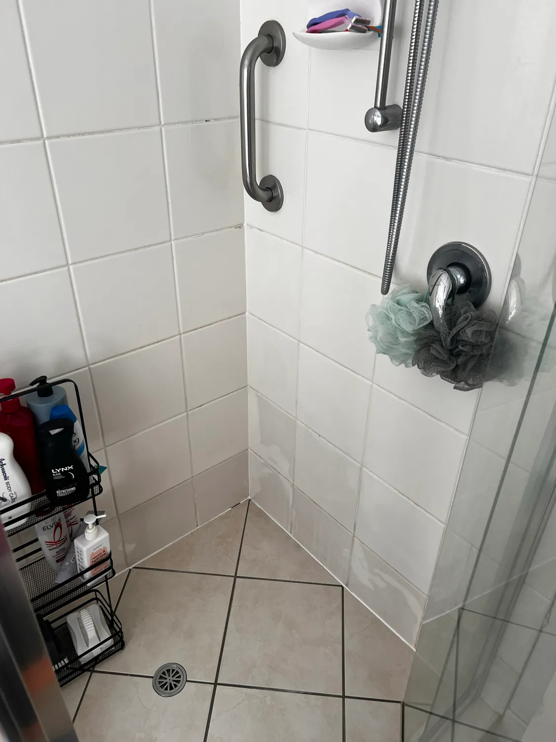 Shower glass door with soap scum after cleaning