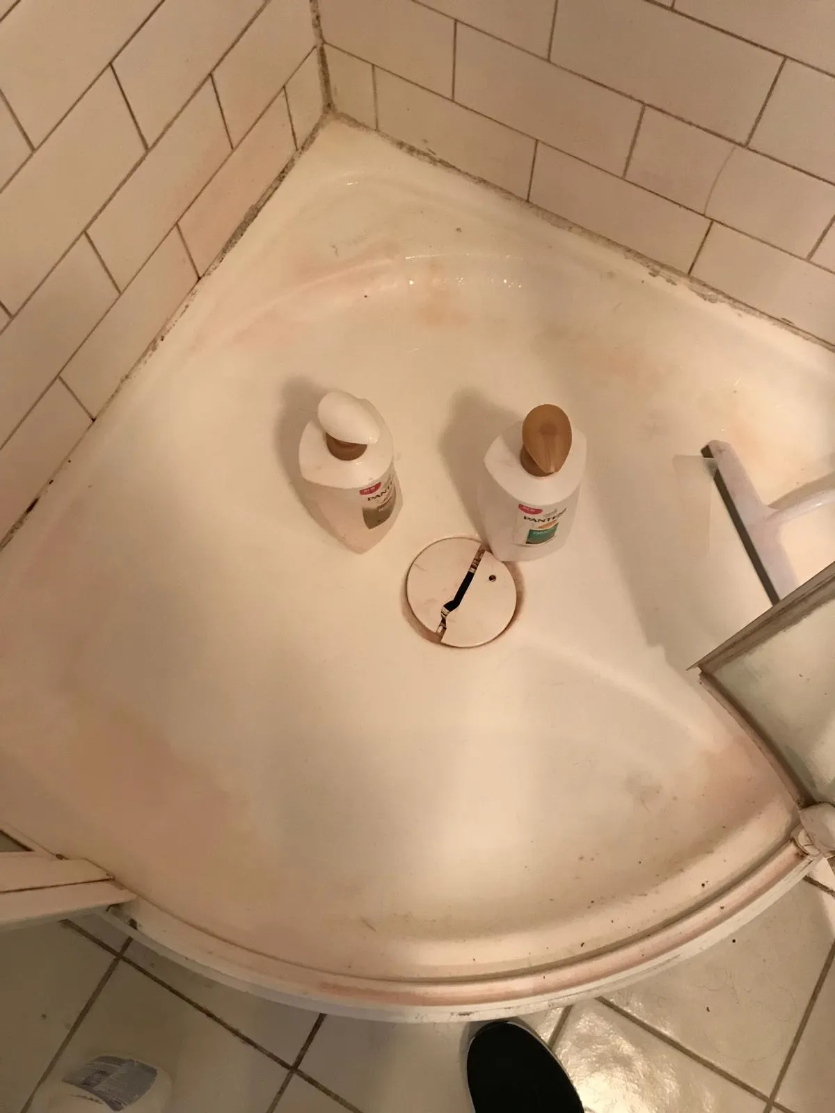 Shower corner floor before cleaning