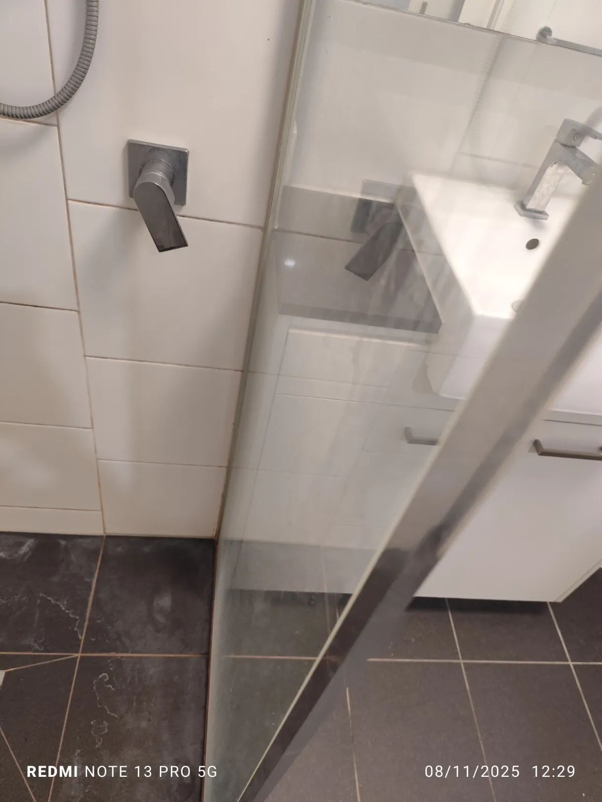 Shower glass viewed from vanity before cleaning