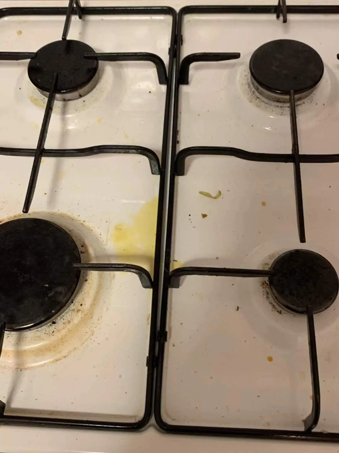 Gas cooktop with grease stains before cleaning