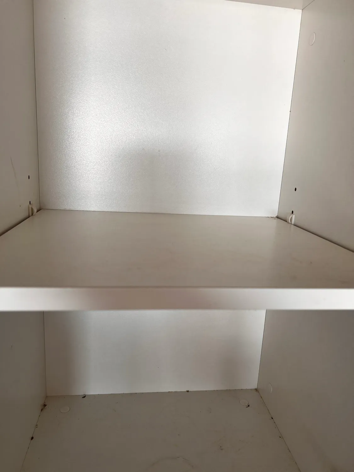 Cupboard interior shelf before cleaning