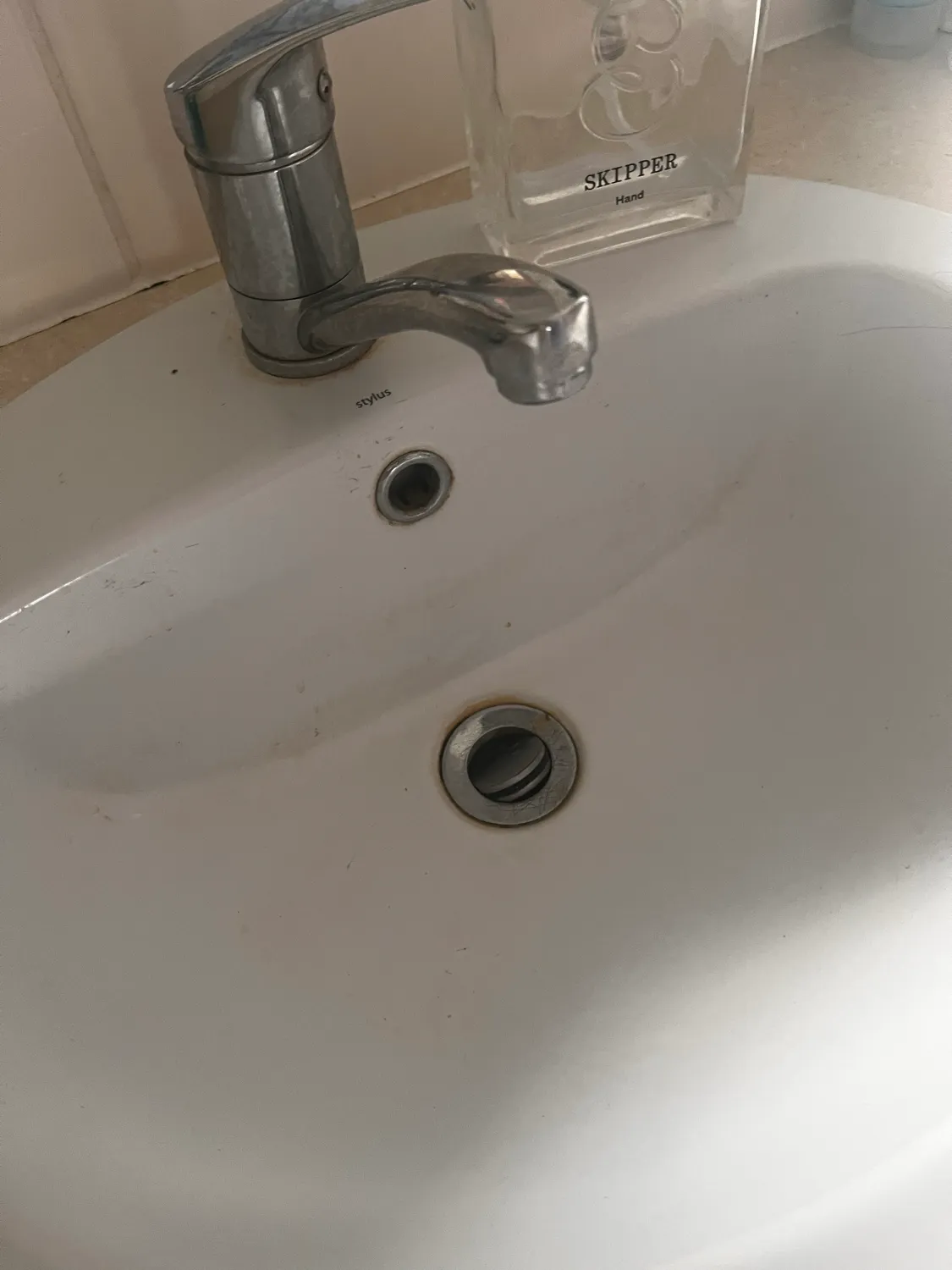 Bathroom sink with calcium buildup before cleaning