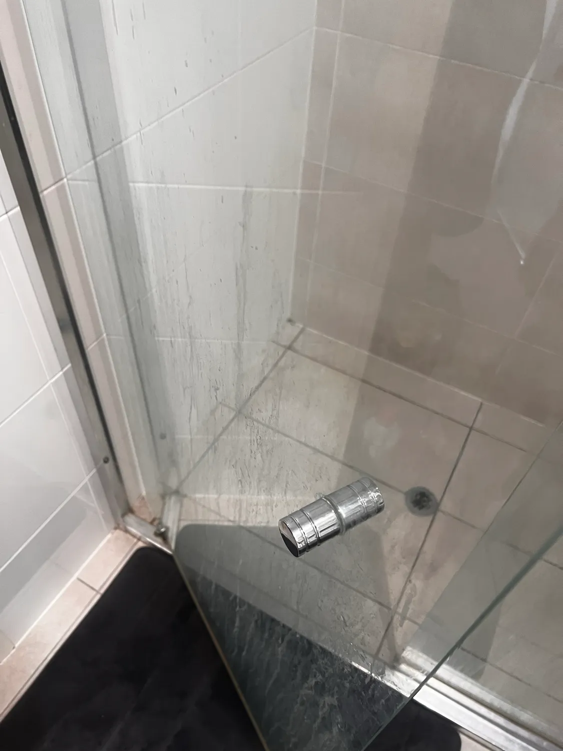 Shower glass with cleaning products before cleaning