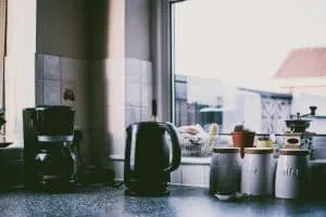Coffee maker and kettle on kitchen bench top