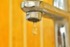 Tap with a droplet of water coming out